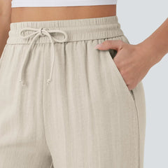 Beige elastic waist trousers with drawstring ties detail at waistband