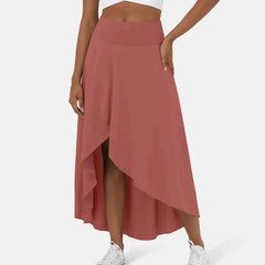 Asymmetric midi skirt in terracotta red with high-low hem and draped side panel