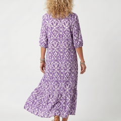 Back view of purple printed midi dress with tie-neck and tiered hem