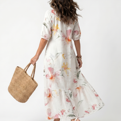 Back view of white floral tiered midi dress with three-quarter puff sleeves
