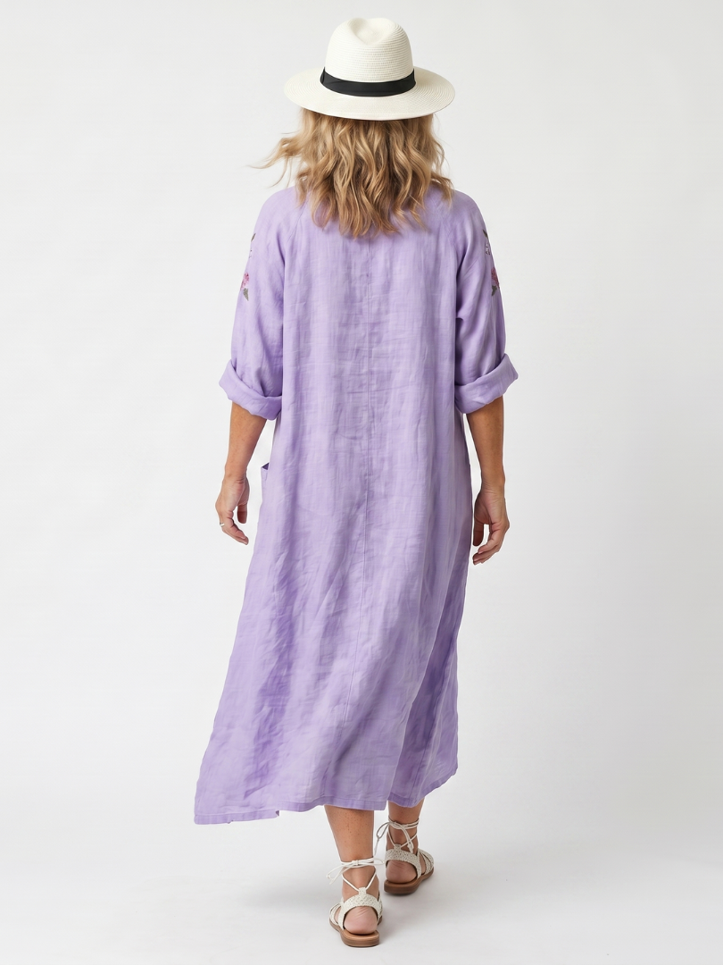 Purple floral pocket midi dress, back view, elbow-length puff sleeves