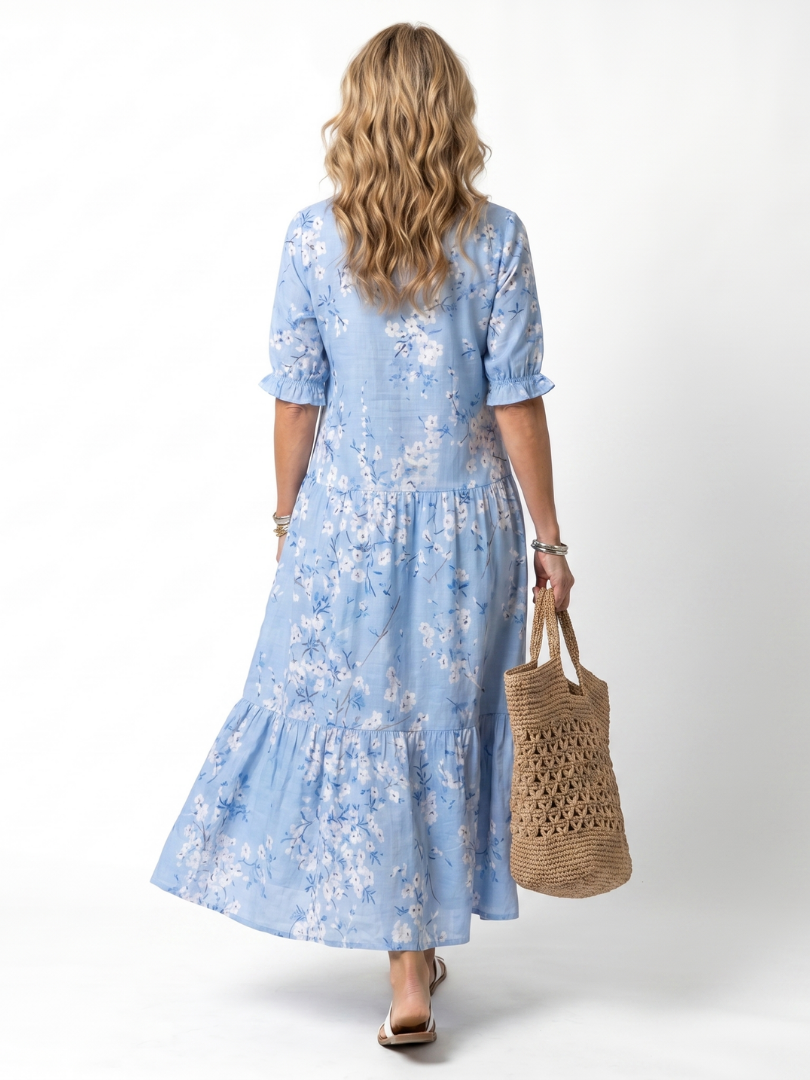 Light blue floral midi dress from back view with V-neck and tiered skirt