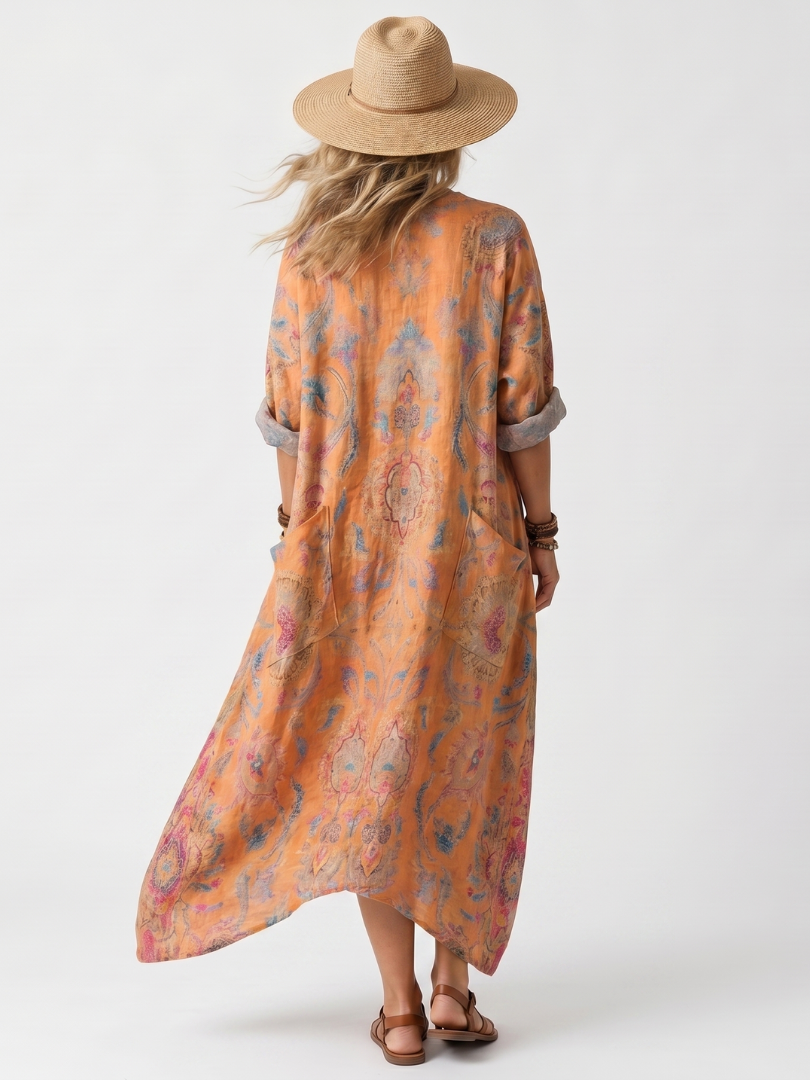 Orange printed midi dress, back view, with half sleeves and draped hem