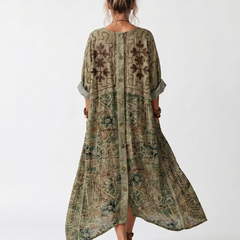 Green printed midi dress back view with button placket and draped asymmetrical hem
