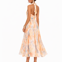 Halter watercolor maxi dress with peach and blue floral print, open back tie at neck