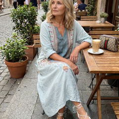 Sky blue pocket midi dress with embroidered neckline, side view