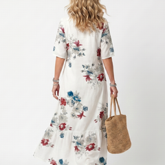 White floral midi dress, back view with short sleeves and tiered hem