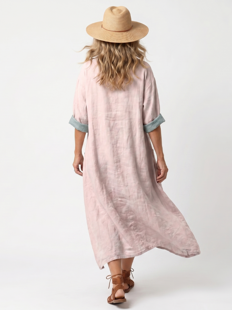 Pink midi dress back view with turquoise cuff trim and relaxed pocketed cut