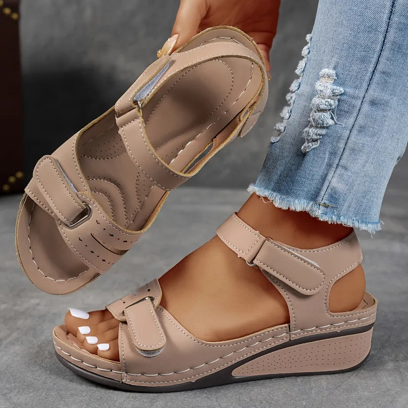 Beige supportive wedge sandals with two buckled straps and open toe
