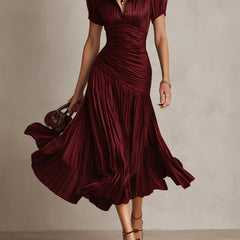 Red striped satin midi dress with V-neck, ruched waist, short sleeves, flowing pleated skirt.