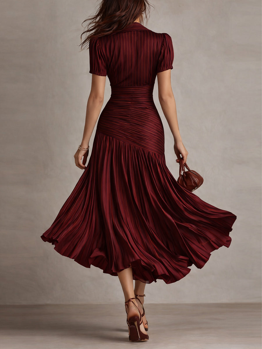 Red striped satin midi dress from back, fitted ruched waist and full pleated skirt.