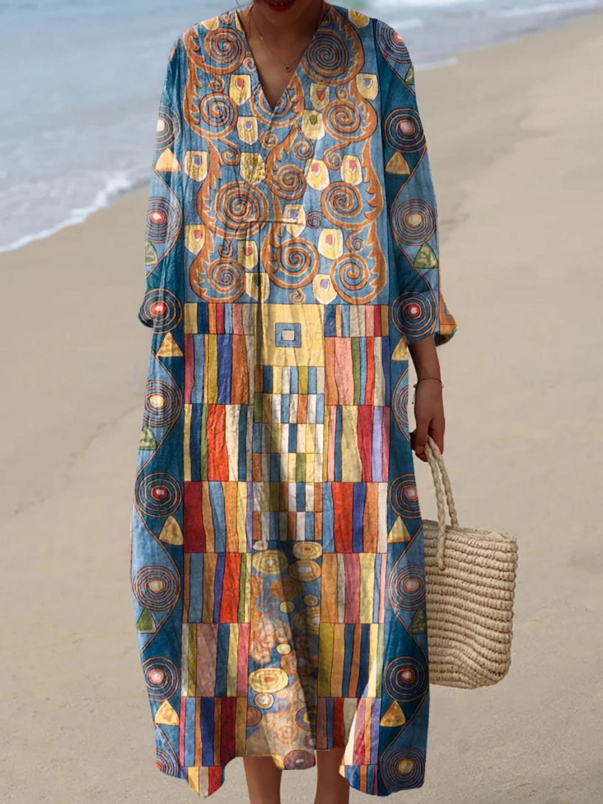 Boho maxi dress with V-neck, multicolor geometric print in blue, gold, and orange.