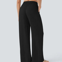 Black wide-leg trousers with elastic waist and drawstring, wide relaxed legs.