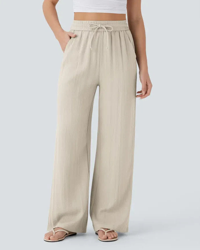 Beige wide-leg trousers with elastic waistband and drawstring ties