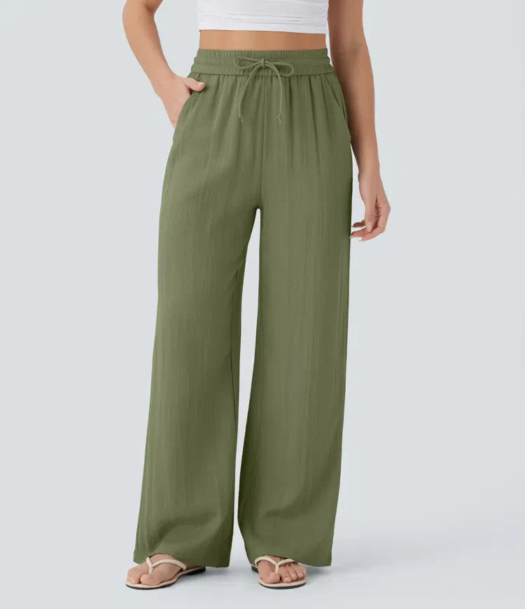 Green wide-leg trousers with elastic waistband and drawstring ties
