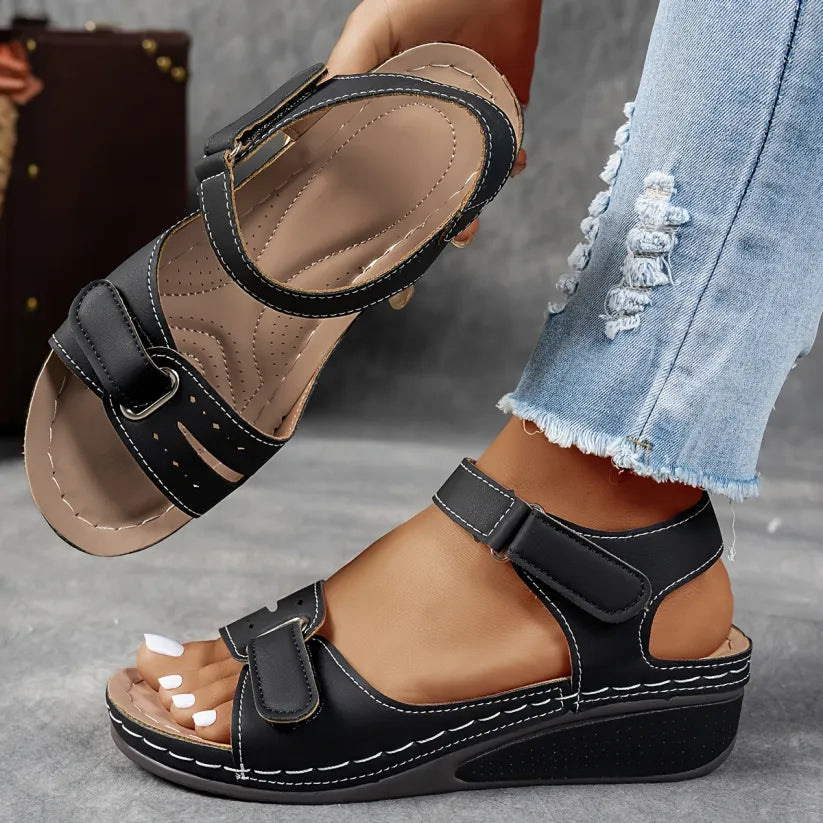 Black supportive wedge sandals with two buckled straps and open toe