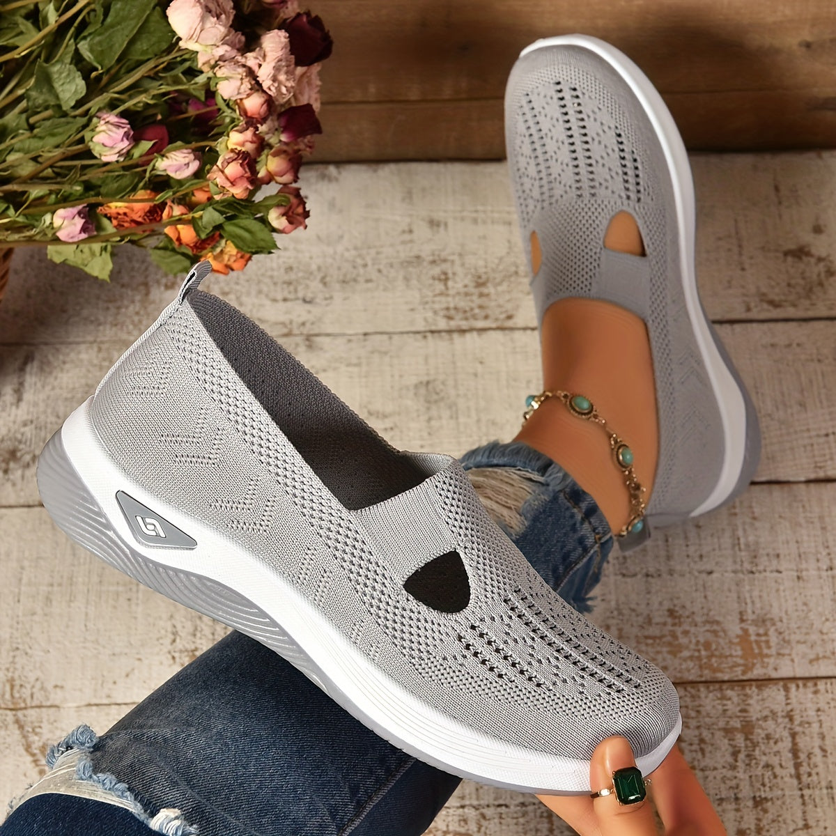 Light gray knit slip-on shoes with side cutouts and white sole