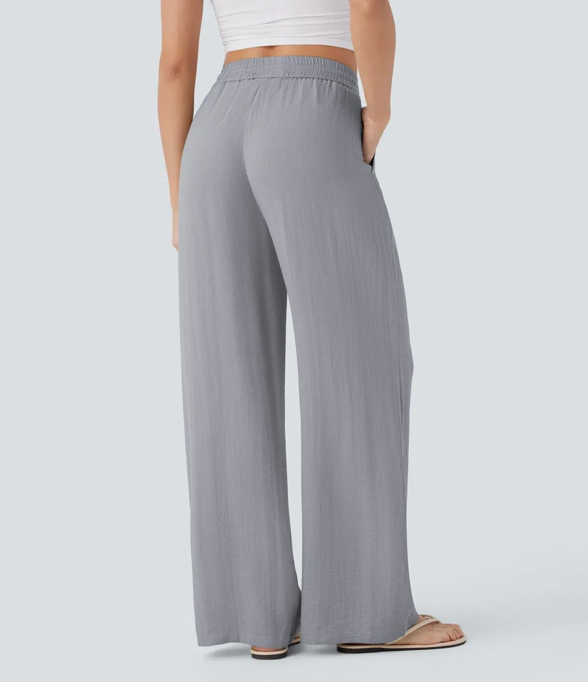 Grey wide-leg trousers with elastic waist and drawstring, full-length wide leg.