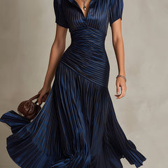 Dark blue striped satin midi dress with V-neck, ruched bodice, short sleeves, pleated skirt.