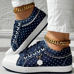 Navy lace-up floral sneakers with white dots and stitched trim, chunky rubber sole.