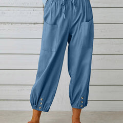 Sky blue relaxed-fit trousers with elastic waist, drawstring, side pockets, button cuff hem.