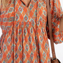 Geometric print V-neck tiered midi dress bodice, orange with blue diamond pattern