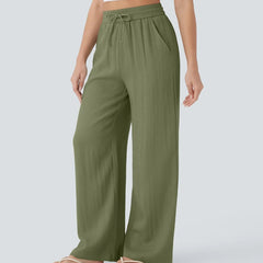 Olive green wide-leg trousers with elastic waist and drawstring, full-length fit.