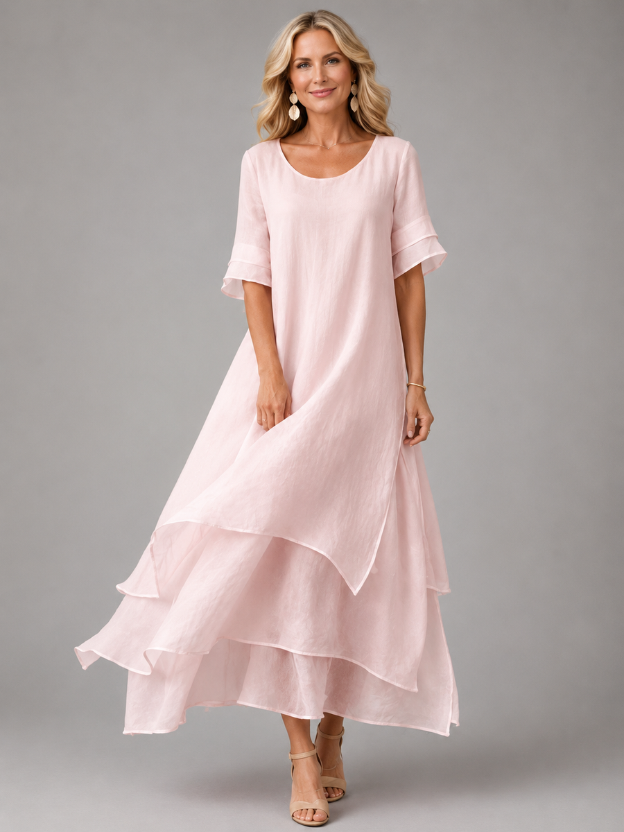 Pink flowing maxi dress with short sleeves and tiered ruffle hem