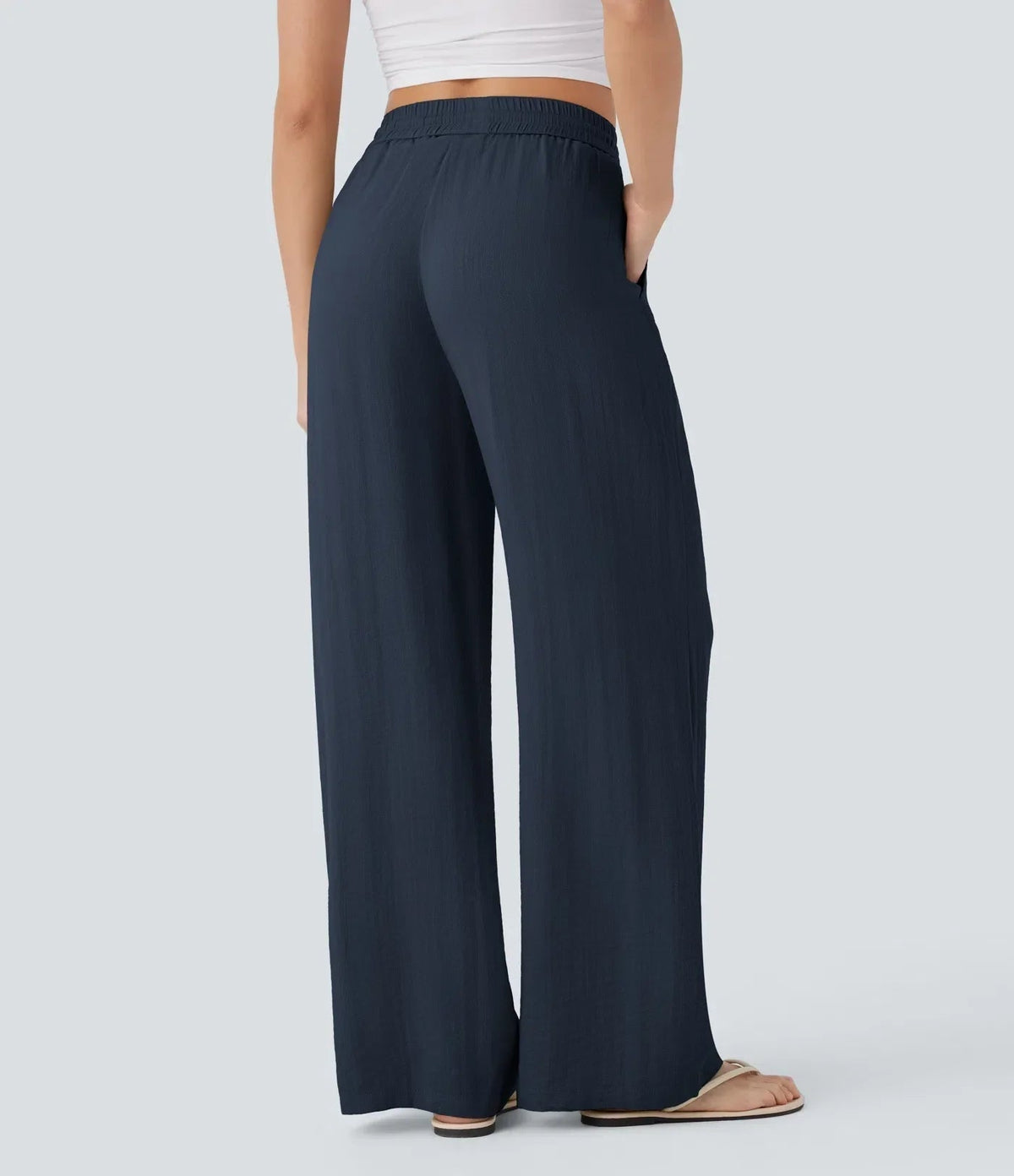 Navy blue wide-leg trousers with elastic waist and drawstring, relaxed fit.