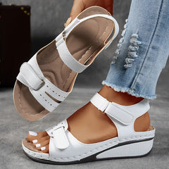 White supportive wedge sandals with two buckled straps and open toe