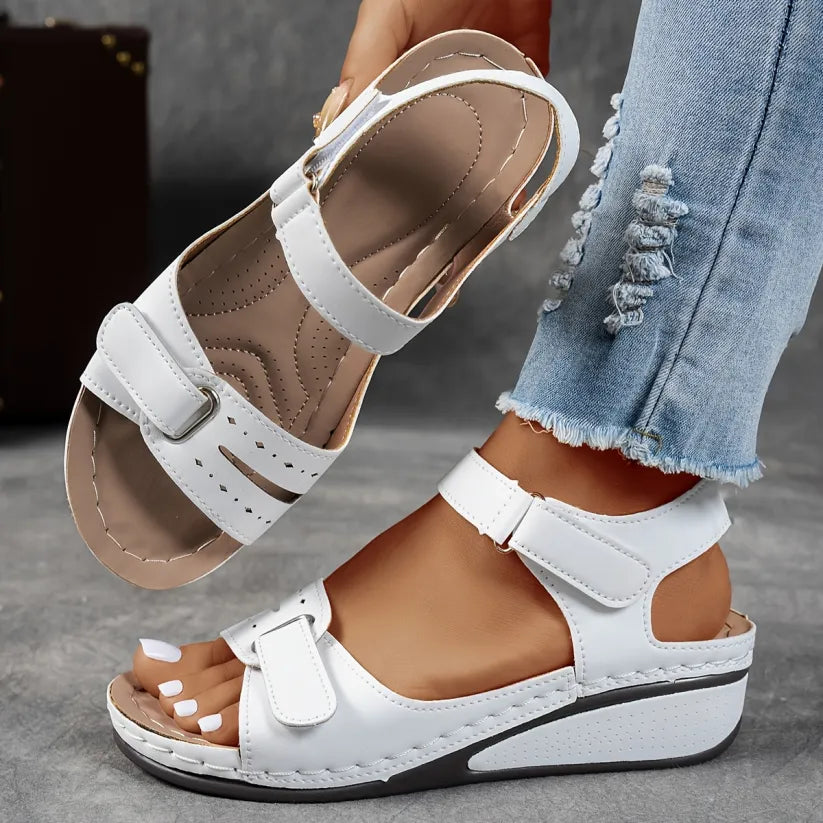 White supportive wedge sandals with two buckled straps and open toe