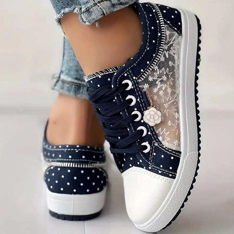 Navy canvas floral sneakers with lace-up closure, white dotted side panel and chunky sole.