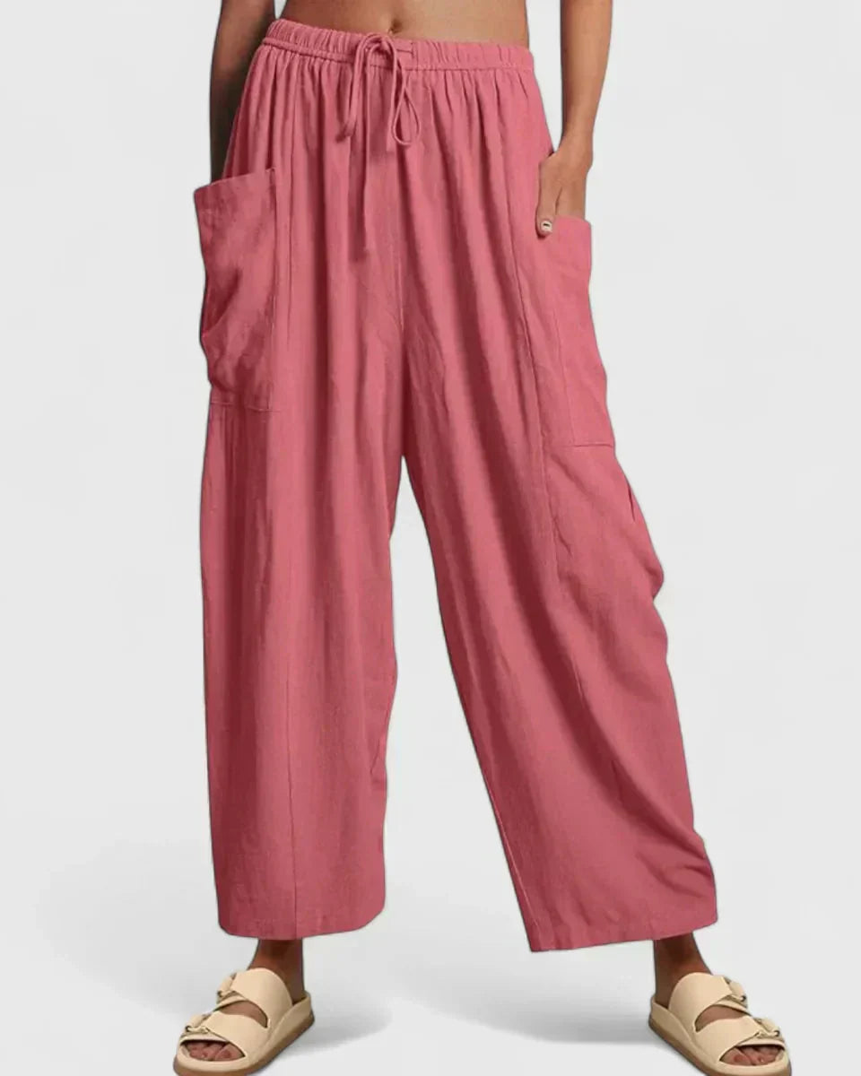 Pink wide-leg trousers with elastic waist and drawstring, side cargo pockets.