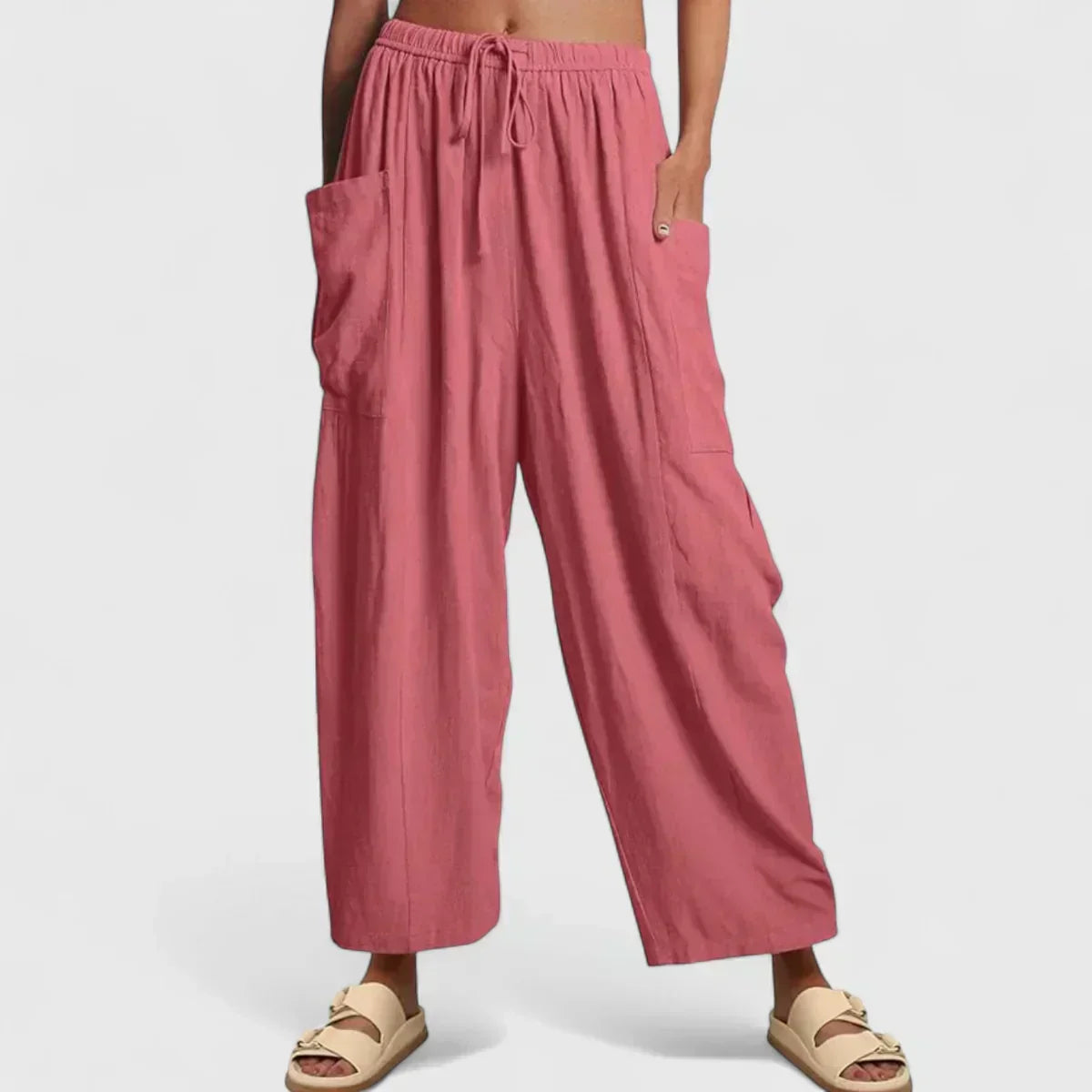 Dusty pink wide-leg trousers with elastic waist and drawstring, side cargo pockets.