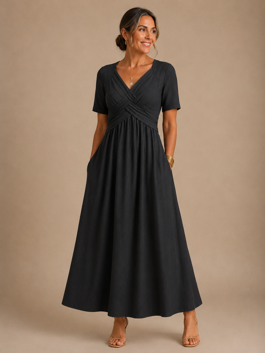Black midi dress with V-neck, short sleeves, cross-over bodice, and gathered skirt