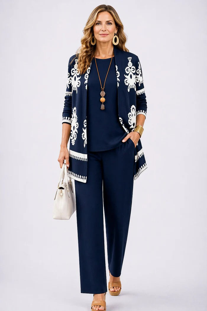 Navy three-piece trouser set with white ornate cardigan and matching top and trousers