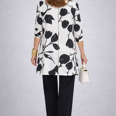 Three-piece trouser set back view: white floral jacket with black trousers