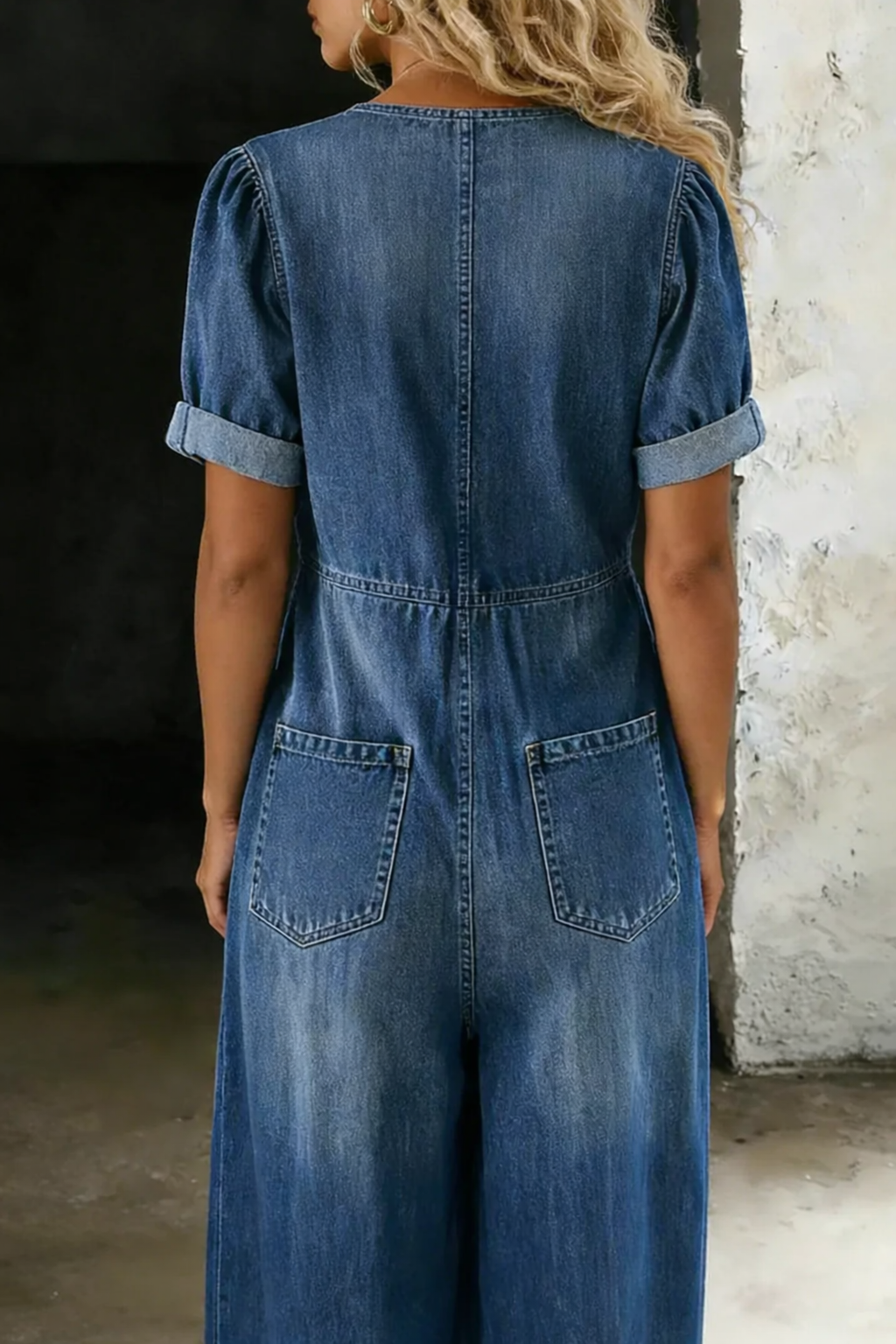 Back-view blue denim short-sleeve overall with yoke seam and two back pockets