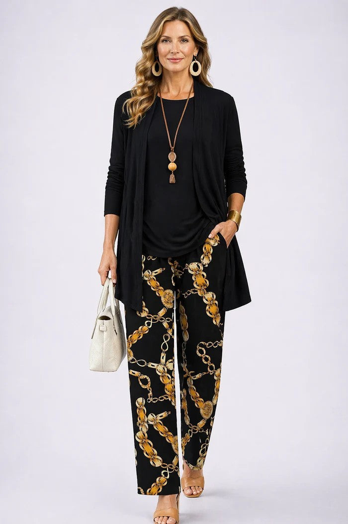 Black three-piece trouser set with long cardigan and gold-chain patterned trousers
