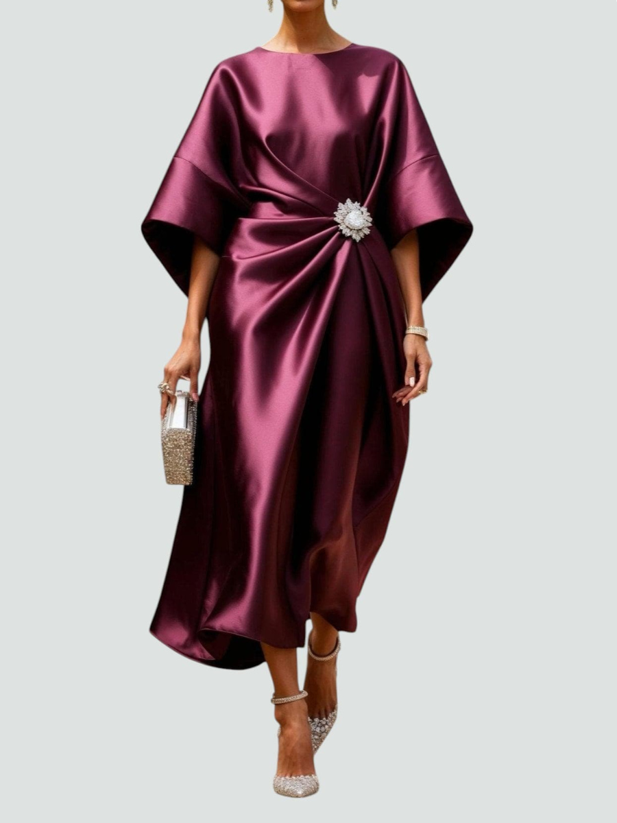 Burgundy satin midi dress with draped dolman sleeves and jeweled waist detail