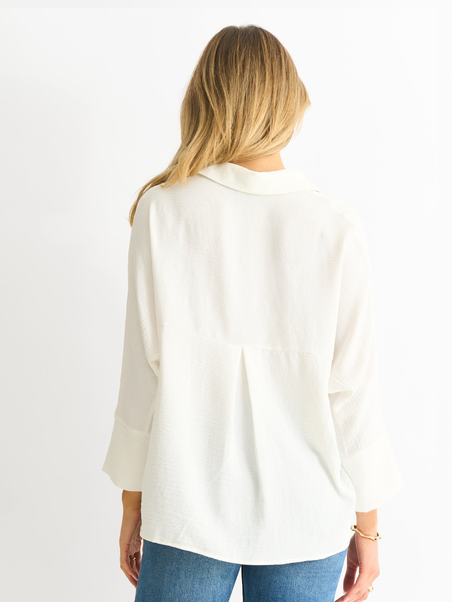 White oversized kimono blouse, back view with collar and button placket