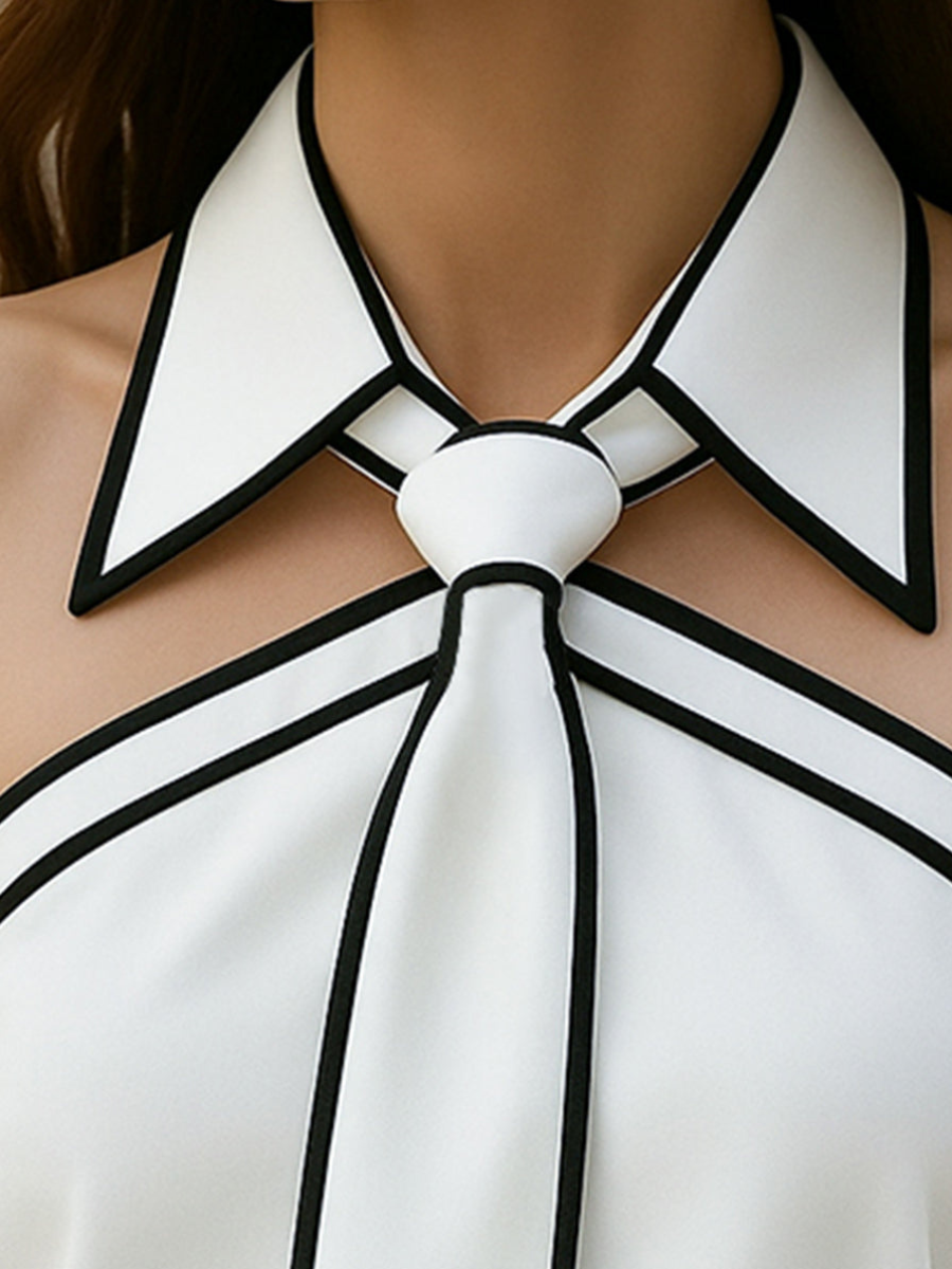 Women’s halter neck blouse neckline close-up: white fabric with black contrast trim