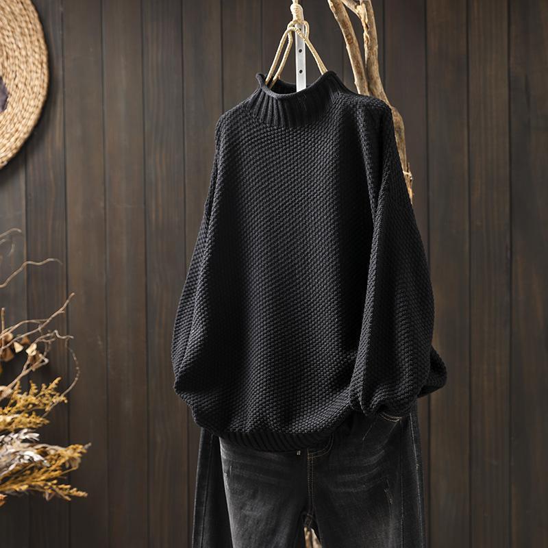 Black waffle-knit sweater with mock neck, loose relaxed fit, ribbed cuffs and hem