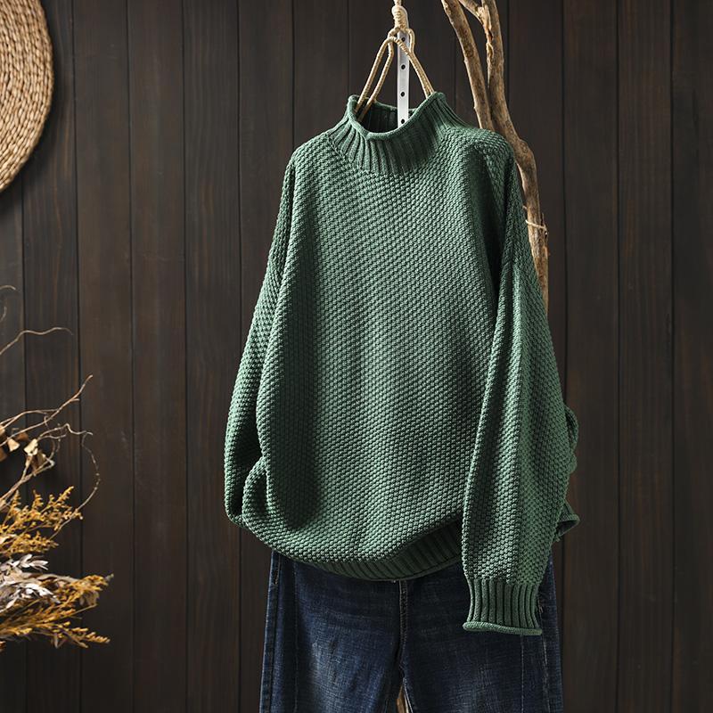 Green waffle-knit sweater with mock neck, long sleeves, ribbed cuffs and hem