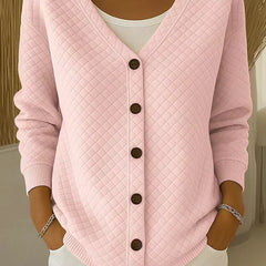 Pink quilted button-front cardigan with V-neck and long sleeves.