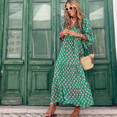 Green boho maxi dress with pink dot print, tiered hem, loose fit and long length
