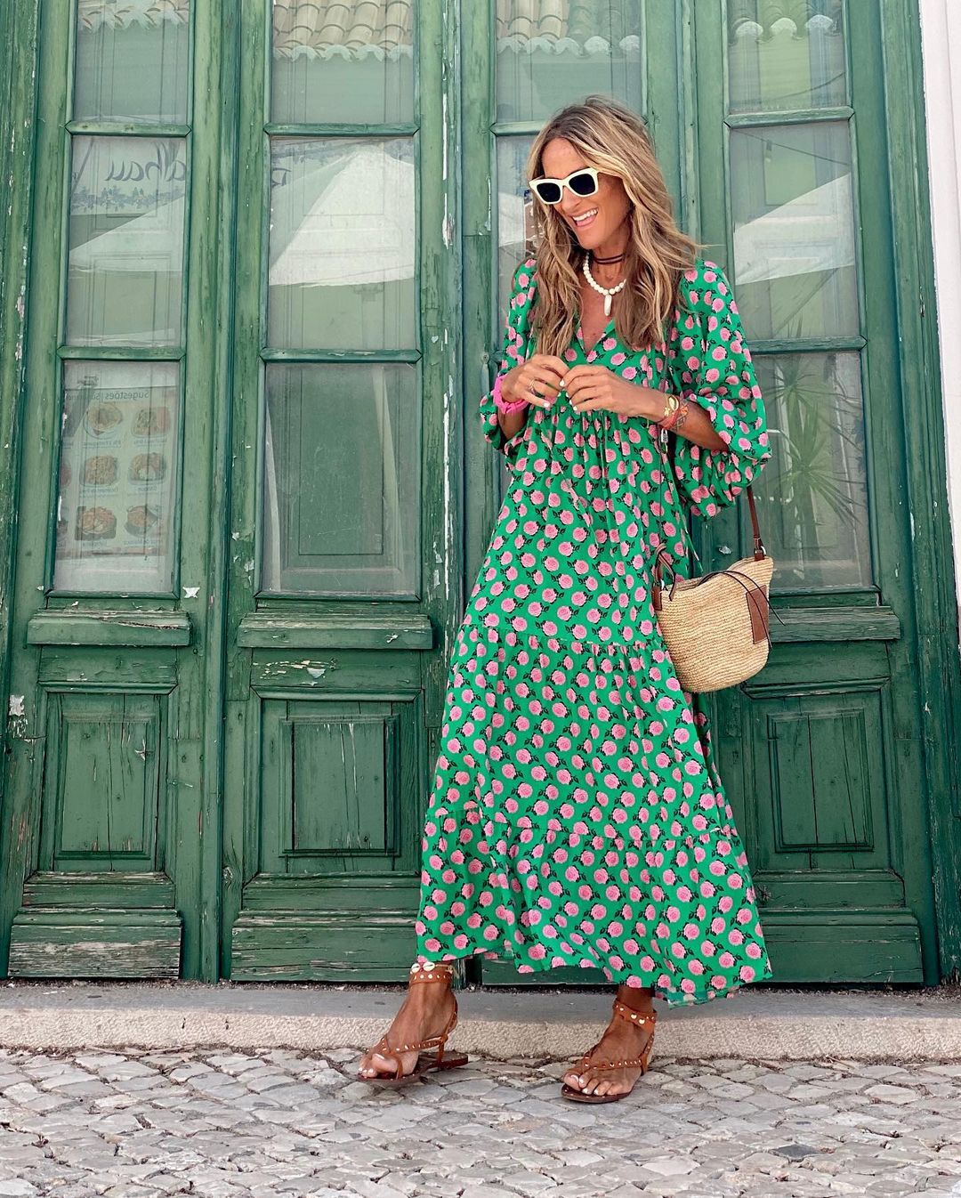 Green boho maxi dress with pink dot print, tiered hem, loose fit and long length