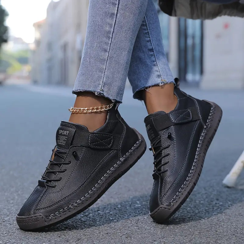 Black orthopaedic trainers with lace-up front and padded side strap