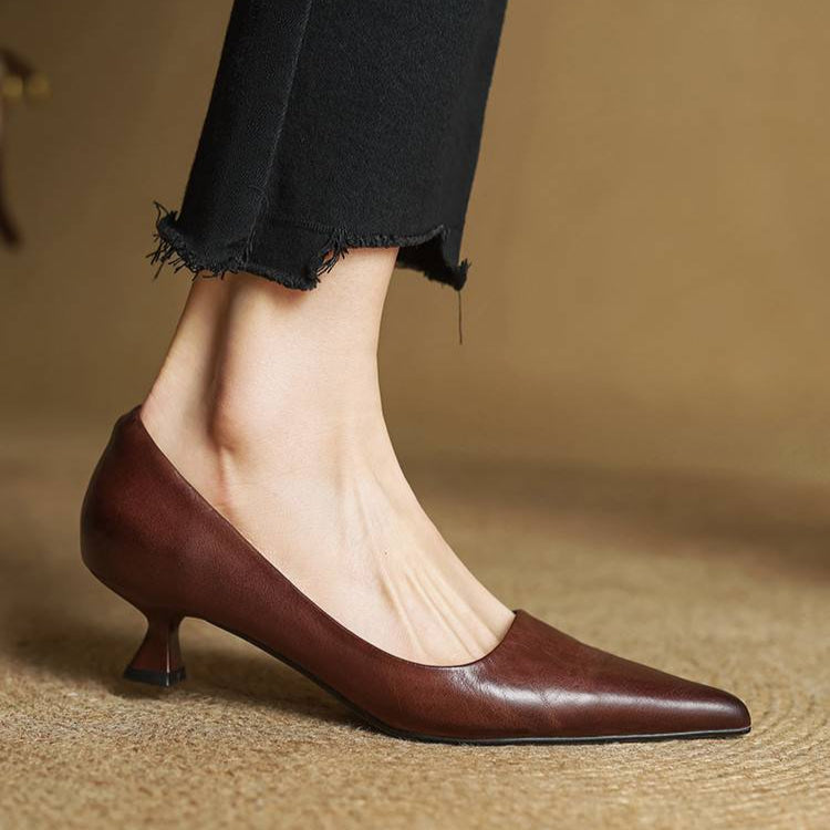 Burgundy leather pointed-toe pumps with low block heel and clean side profile