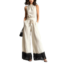 White halter-neck lace-trim wide-leg jumpsuit with waist belt tie and black lace cuffs